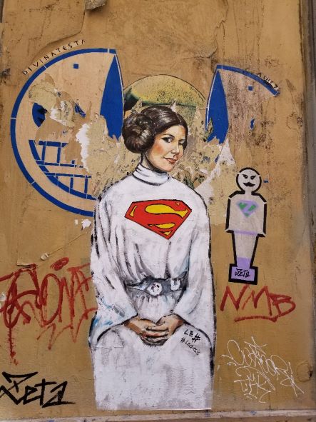 Street art in Florence Italy by artist Lediesis of Princess Leia as Superwoman.